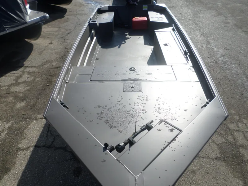 Slide: The Image of 2025 Alweld 1648 VV Marsh boat, aluminum deck, parked on pavement. - 6