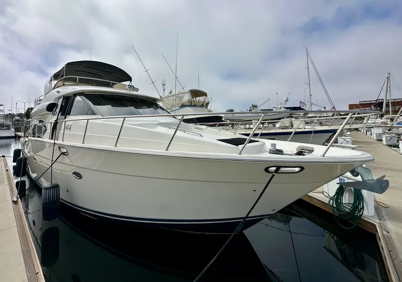 Slide: The Image of 2004 Meridian 580 Pilothouse yacht docked at marina, showcasing sleek design and luxury features. - 19