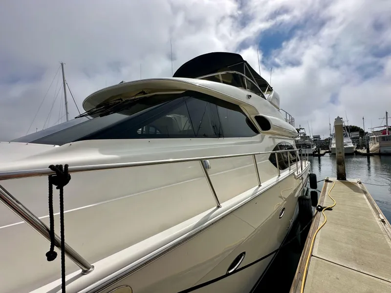 Slide: The Image of 2004 Meridian 580 Pilothouse yacht docked at marina under cloudy sky. - 23