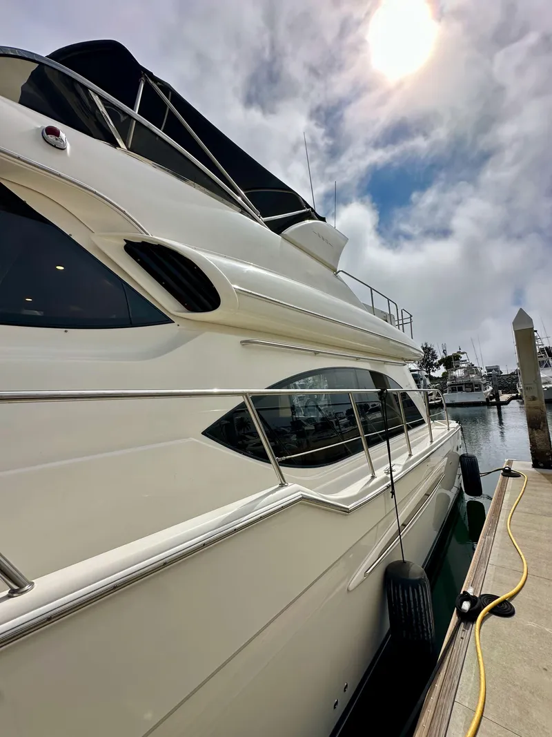 Slide: The Image of 2004 Meridian 580 Pilothouse yacht docked under a cloudy sky. - 24