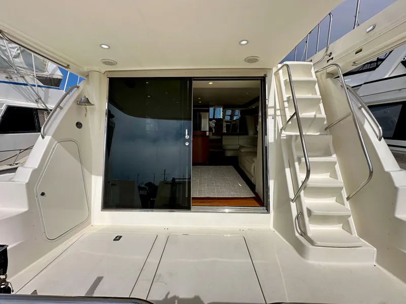 Slide: The Image of 2004 Meridian 580 Pilothouse yacht with open sliding door and staircase to upper deck. - 28