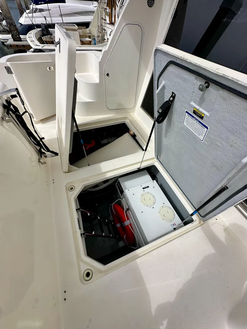 Slide: The Image of Open storage compartments on a 2004 Meridian 580 Pilothouse boat deck. - 29
