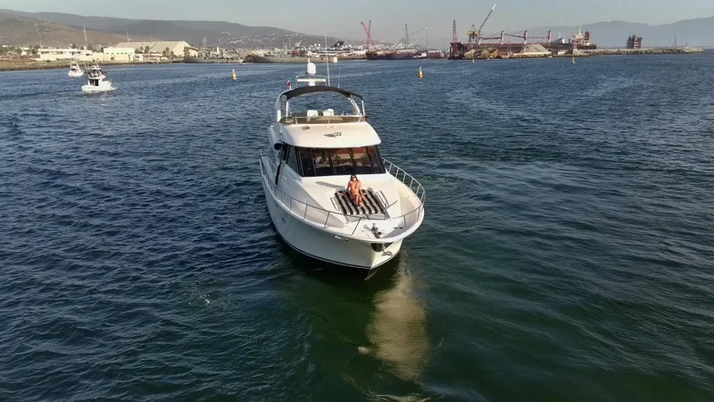 Slide: The Image of 2004 Meridian 580 Pilothouse yacht cruising in a scenic harbor setting. - 3