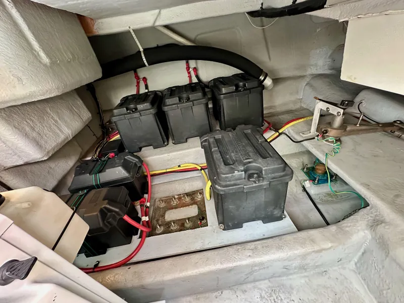 Slide: The Image of Engine room of 2004 Meridian 580 Pilothouse with multiple battery units and wiring. - 32