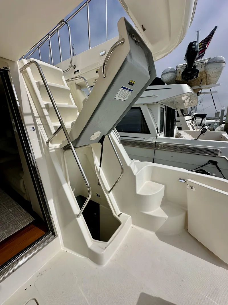 Slide: The Image of 2004 Meridian 580 Pilothouse yacht with stairs to upper deck, docked in marina. - 34