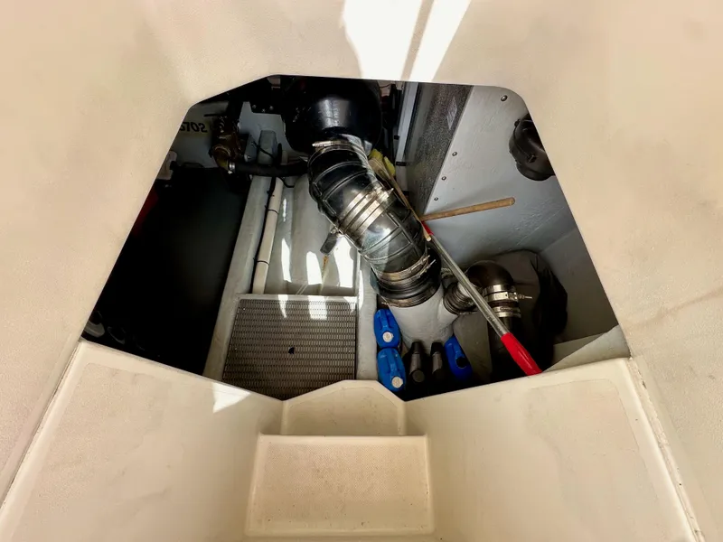 Slide: The Image of Engine compartment of 2004 Meridian 580 Pilothouse, showing mechanical components and tools. - 35