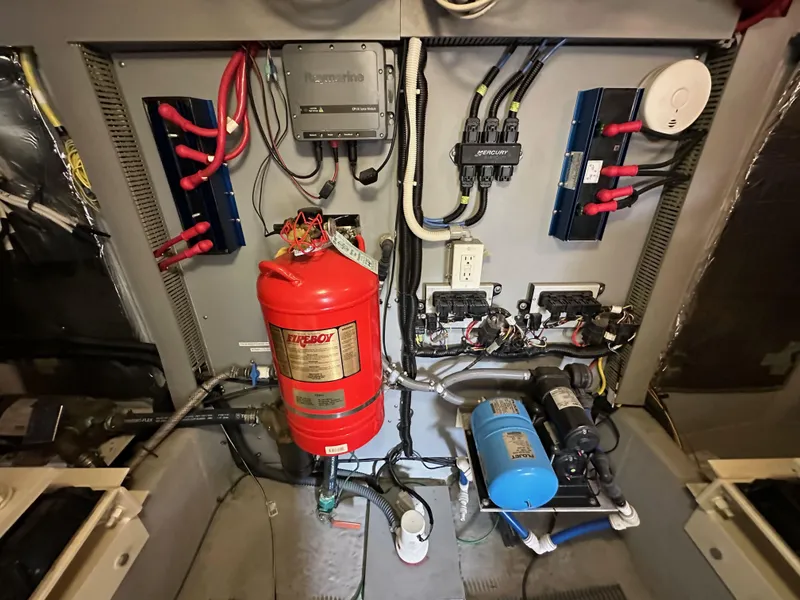 Slide: The Image of Engine room of 2004 Meridian 580 Pilothouse with fire extinguisher and electrical components. - 45