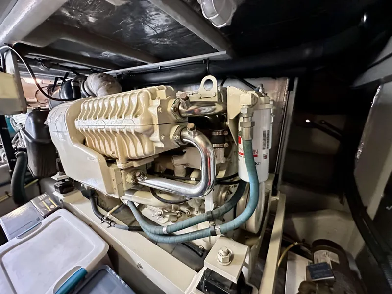 Slide: The Image of Engine room of 2004 Meridian 580 Pilothouse yacht, showcasing mechanical components and piping. - 46