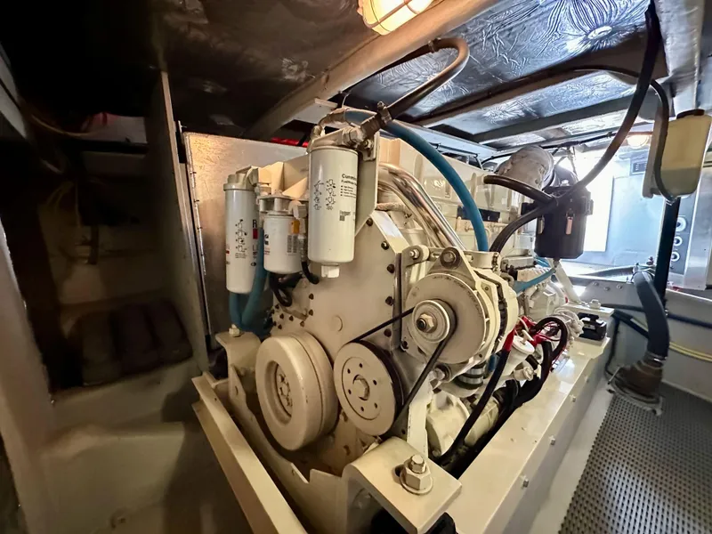 Slide: The Image of Engine room of 2004 Meridian 580 Pilothouse yacht, showcasing mechanical components. - 47