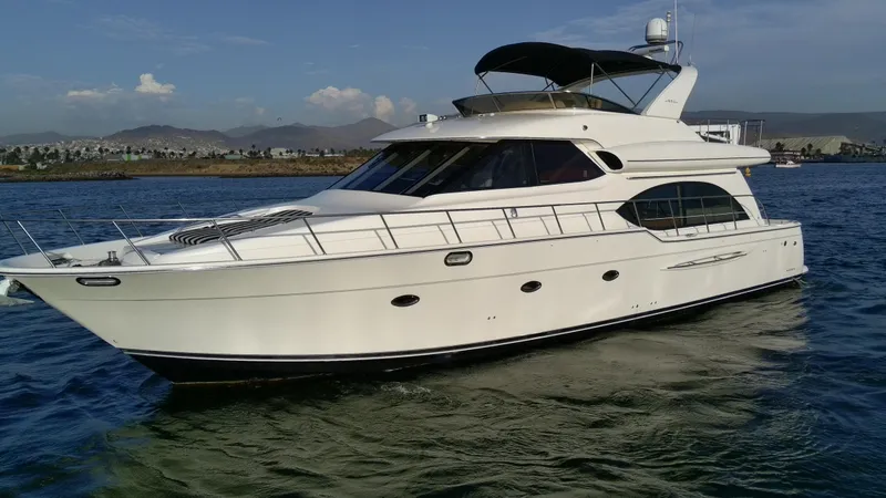 Slide: The Image of 2004 Meridian 580 Pilothouse yacht cruising on open water. - 8