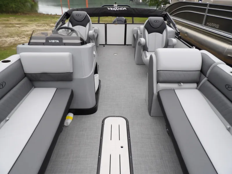 Slide: The Image of 2025 Veranda Vista Sport 22RC pontoon boat interior with gray seating and steering console. - 11
