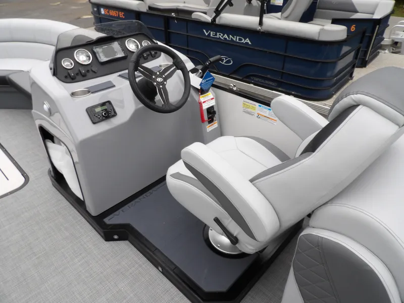 Slide: The Image of 2025 Veranda Vista Sport 22RC boat interior with steering console and captain's chair. - 15