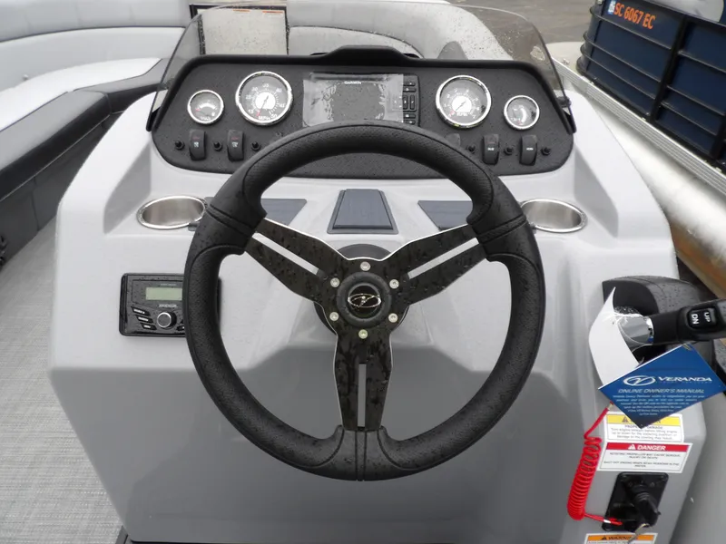 Slide: The Image of 2025 Veranda Vista Sport 22RC boat dashboard with steering wheel and control panel. - 5