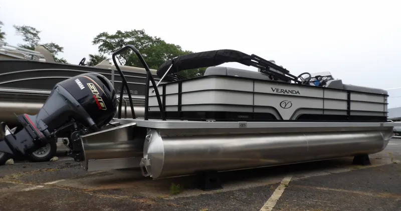 Slide: The Image of 2025 Veranda Vista Sport 22RC pontoon boat with Yamaha outboard motor, parked on land. - 8