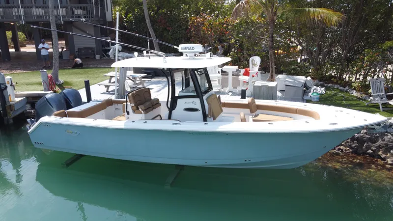 The Image of 2020 Sea Hunt Gamefish 30 Forward Seating boat docked in clear water. - 0
