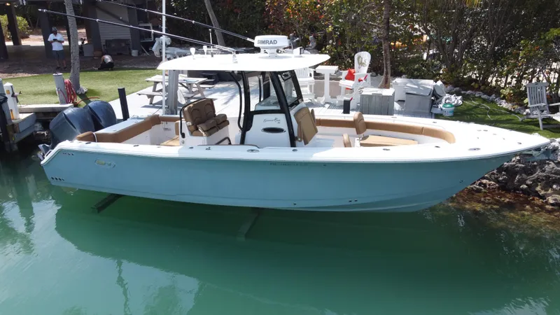 Slide: The Image of 2020 Sea Hunt Gamefish 30 Forward Seating boat docked in clear water. - 1