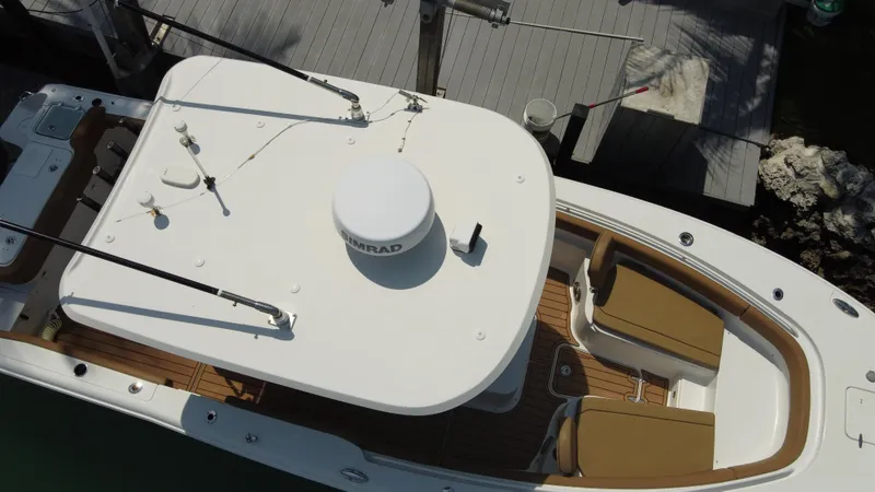 Slide: The Image of 2020 Sea Hunt Gamefish 30 boat with forward seating, docked aerial view. - 10