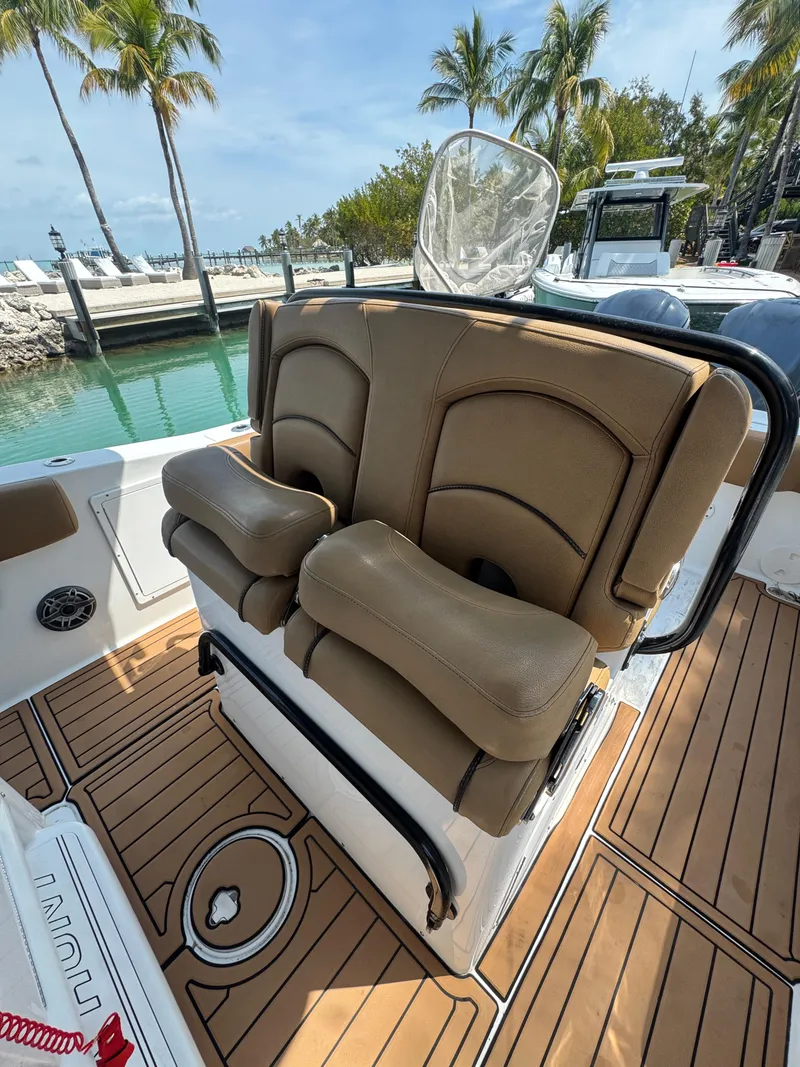 Slide: The Image of 2020 Sea Hunt Gamefish 30 boat with forward seating, docked near palm trees. - 20