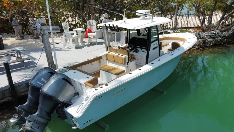 Slide: The Image of 2020 Sea Hunt Gamefish 30 boat docked in clear water, featuring forward seating. - 23