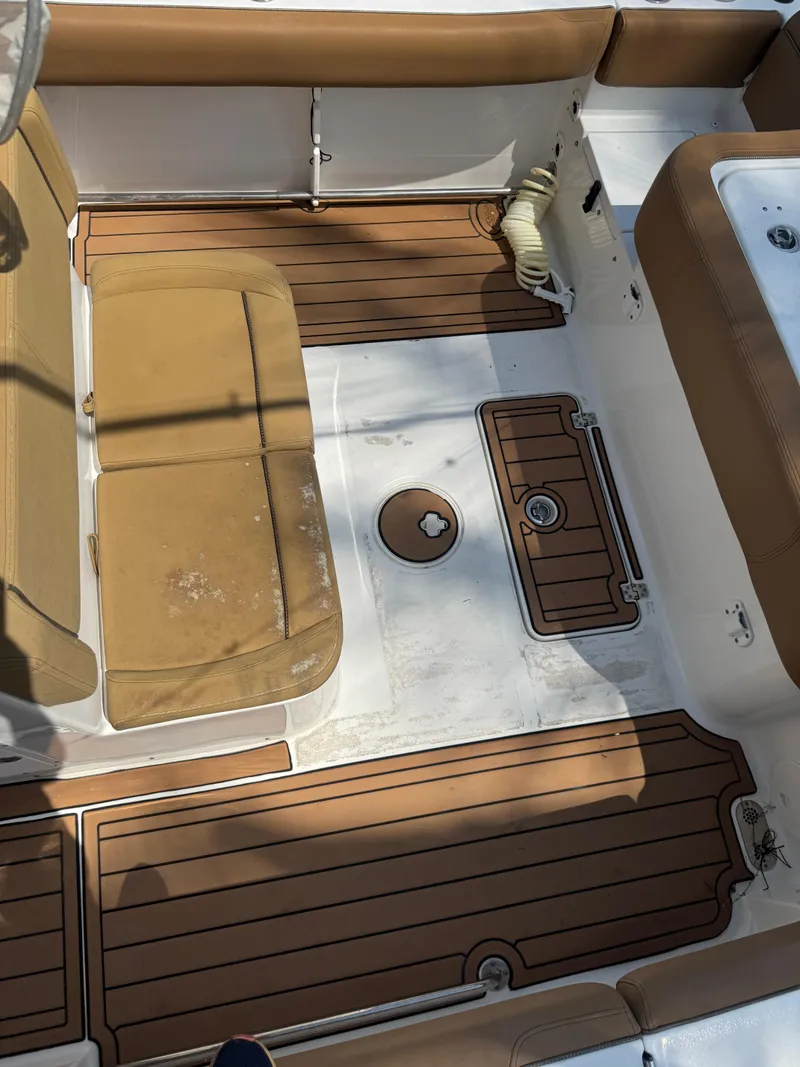 Slide: The Image of 2020 Sea Hunt Gamefish 30 Forward Seating boat interior with tan cushions and wood-style flooring. - 29