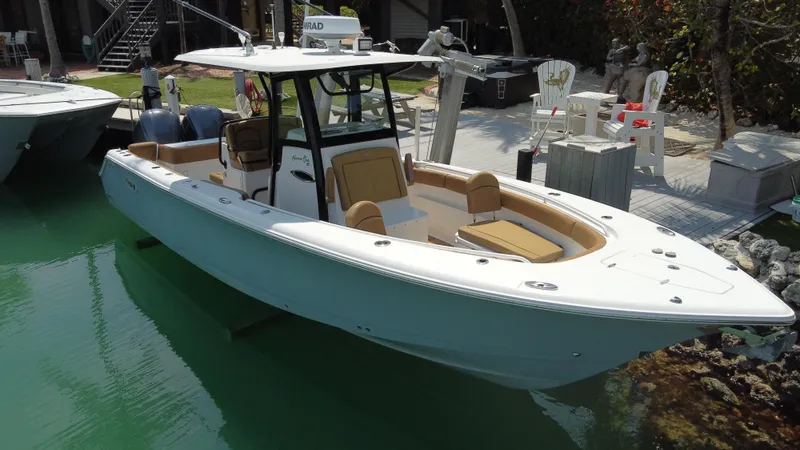 Slide: The Image of 2020 Sea Hunt Gamefish 30 boat with forward seating, docked in a serene marina. - 3