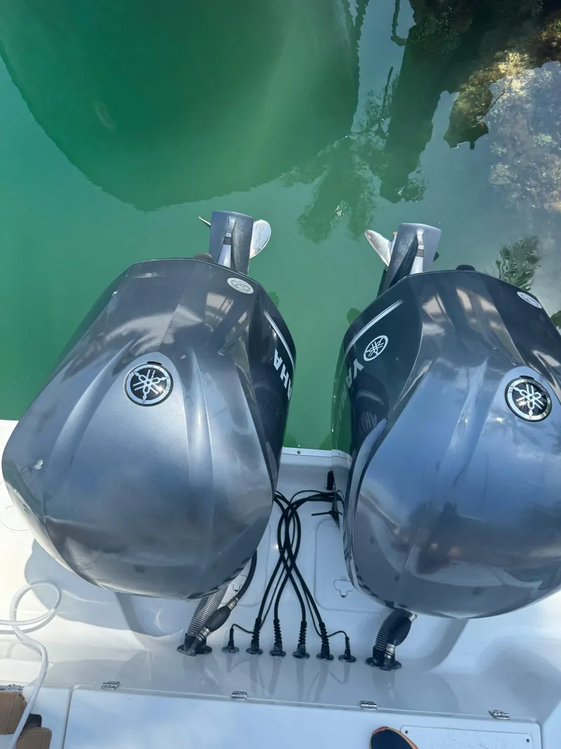 Slide: The Image of 2020 Sea Hunt Gamefish 30 with dual Yamaha outboard motors in clear water. - 30