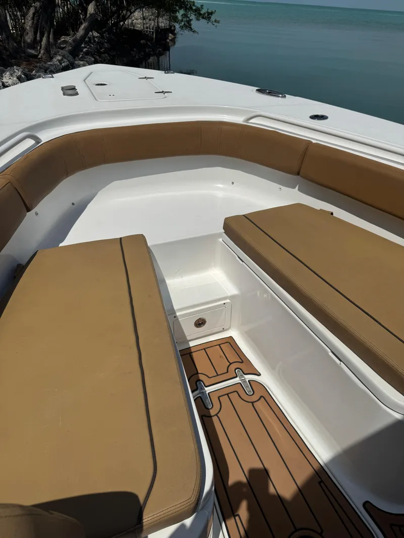 Slide: The Image of 2020 Sea Hunt Gamefish 30 Forward Seating with tan cushions and teak flooring. - 31
