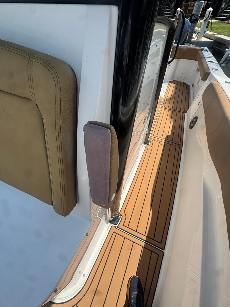 Slide: The Image of 2020 Sea Hunt Gamefish 30 boat with teak flooring and tan seating. - 33