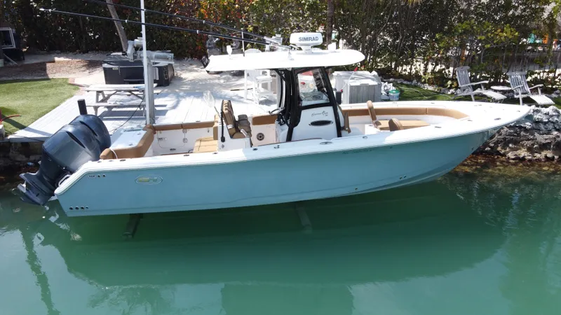 Slide: The Image of 2020 Sea Hunt Gamefish 30 boat with forward seating, docked in clear water. - 35