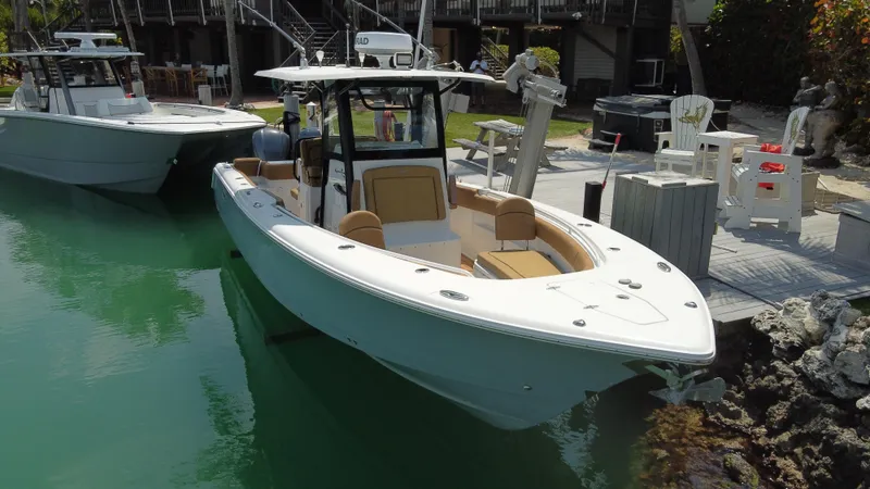Slide: The Image of 2020 Sea Hunt Gamefish 30 Forward Seating boat docked in a marina. - 4