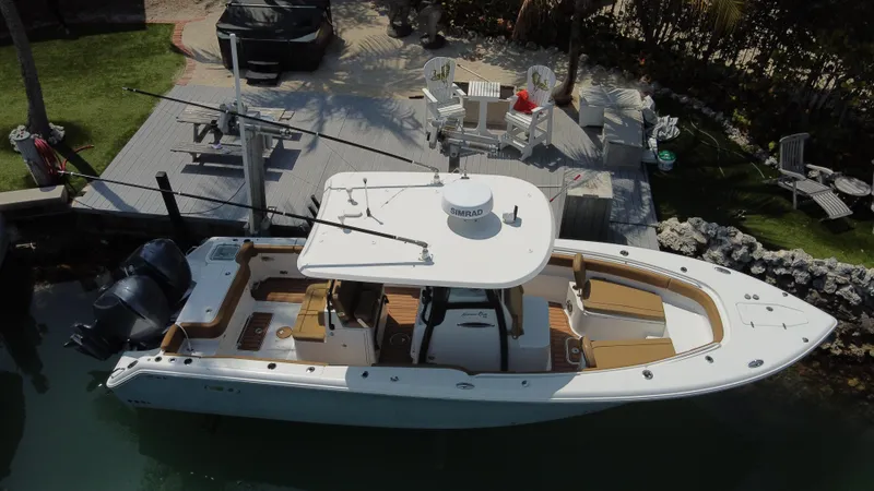 Slide: The Image of 2020 Sea Hunt Gamefish 30 boat docked, aerial view, featuring forward seating and dual engines. - 7