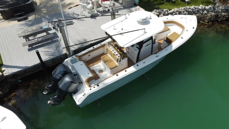 Slide: The Image of 2020 Sea Hunt Gamefish 30 Forward Seating boat docked in clear water. - 8