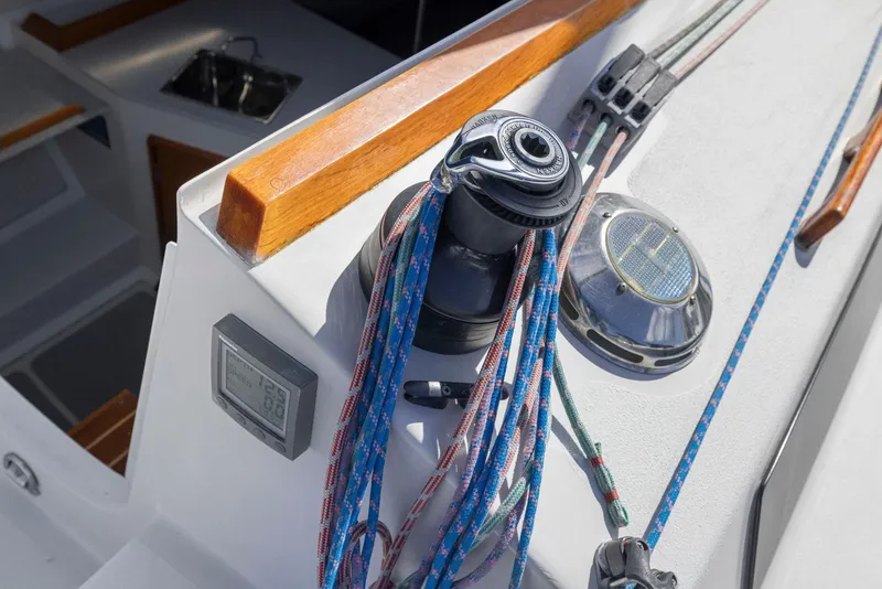 Slide: The Image of 2004 Wyliecat 30 sailboat deck with winch and colorful ropes. - 11