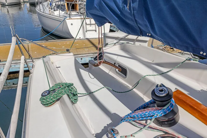 Slide: The Image of 2004 Wyliecat 30 sailboat deck with ropes and winch at marina. - 14