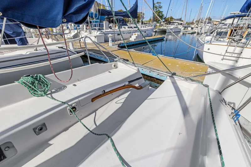 Slide: The Image of 2004 Wyliecat 30 sailboat docked at marina, featuring clean deck and rigging. - 15