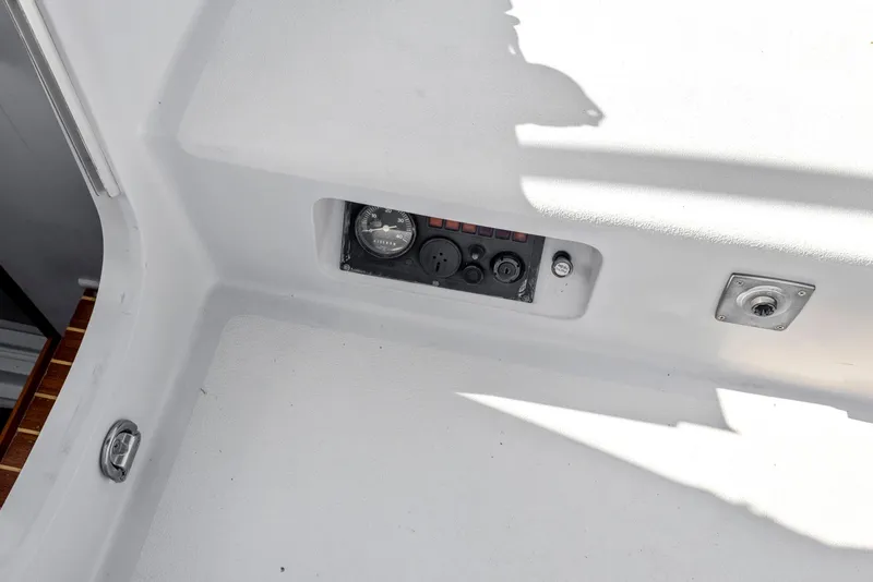 Slide: The Image of Control panel on 2004 Wyliecat 30 sailboat deck, featuring gauges and switches. - 16