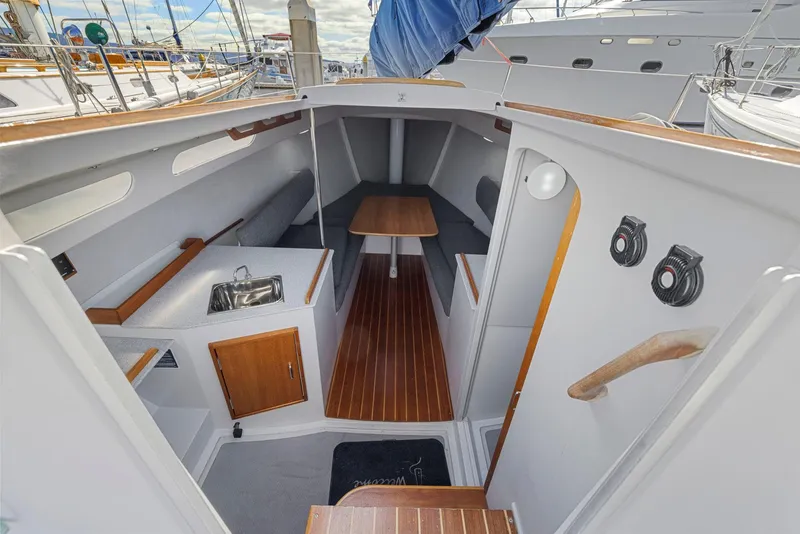 Slide: The Image of 2004 Wyliecat 30 sailboat interior with wood accents and compact layout. - 18