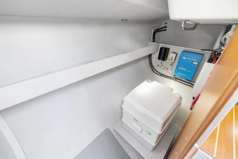 Slide: The Image of Compact interior of 2004 Wyliecat 30 sailboat with portable toilet and electrical panel. - 21