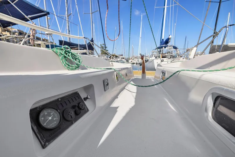 Slide: The Image of 2004 Wyliecat 30 sailboat cockpit with control panel and ropes in a marina. - 25