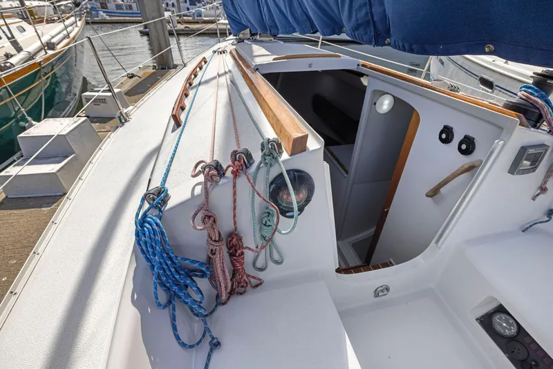 Slide: The Image of 2004 Wyliecat 30 sailboat cockpit with ropes and cabin entrance. - 7
