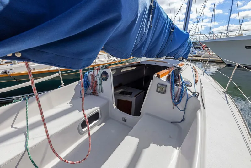 Slide: The Image of 2004 Wyliecat 30 sailboat with blue sail cover docked at marina. - 9