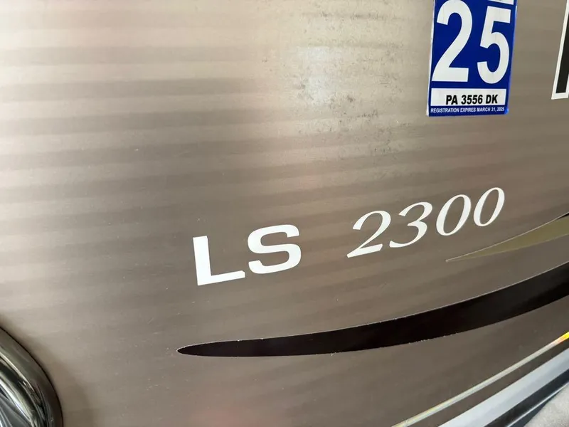 Slide: The Image of 2011 Avalon LS 2300 boat with registration sticker, close-up view. - 13