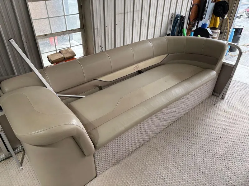Slide: The Image of Beige seating from a 2011 Avalon LS 23' RE boat, in a garage setting. - 14