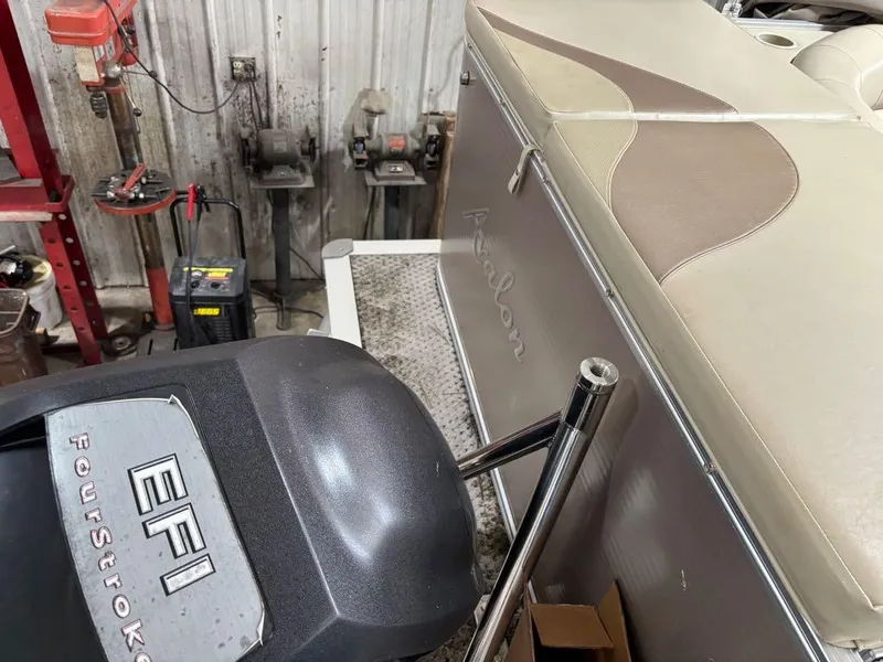 Slide: The Image of 2011 Avalon LS 23' RE boat with EFI FourStroke engine in a workshop setting. - 2