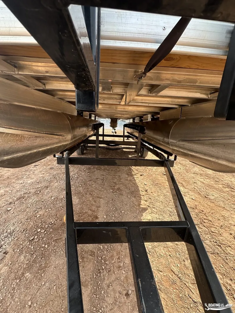 Slide: The Image of Underneath view of a 2020 Tracker Party Barge 24 DLX pontoon boat on a trailer. - 14