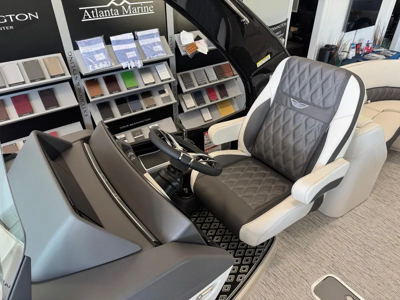 Slide: The Image of 2025 Bennington 25QFBA boat interior with luxury captain's chair and steering console. - 13