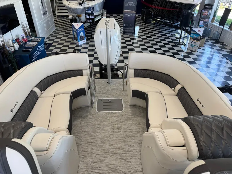 Slide: The Image of Luxurious interior of 2025 Bennington 25QFBA boat with plush seating in showroom. - 14