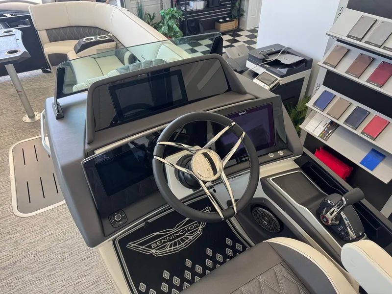 Slide: The Image of 2025 Bennington 25QFBA boat interior with modern steering console and seating. - 17