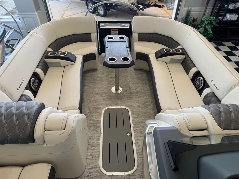 Slide: The Image of Luxurious interior of 2025 Bennington 25QFBA pontoon boat with plush seating and cup holders. - 19
