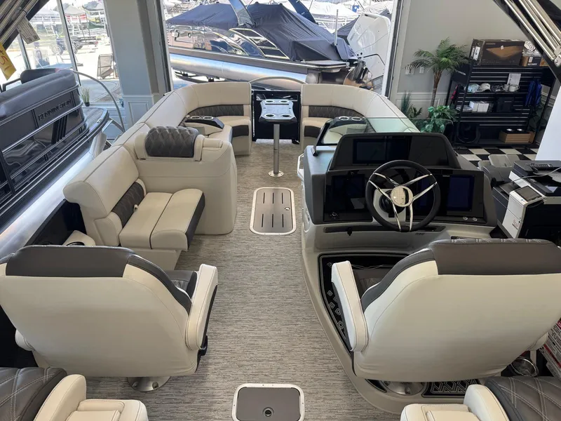 Slide: The Image of Luxurious interior of 2025 Bennington 25QFBA pontoon boat with plush seating and modern helm. - 23